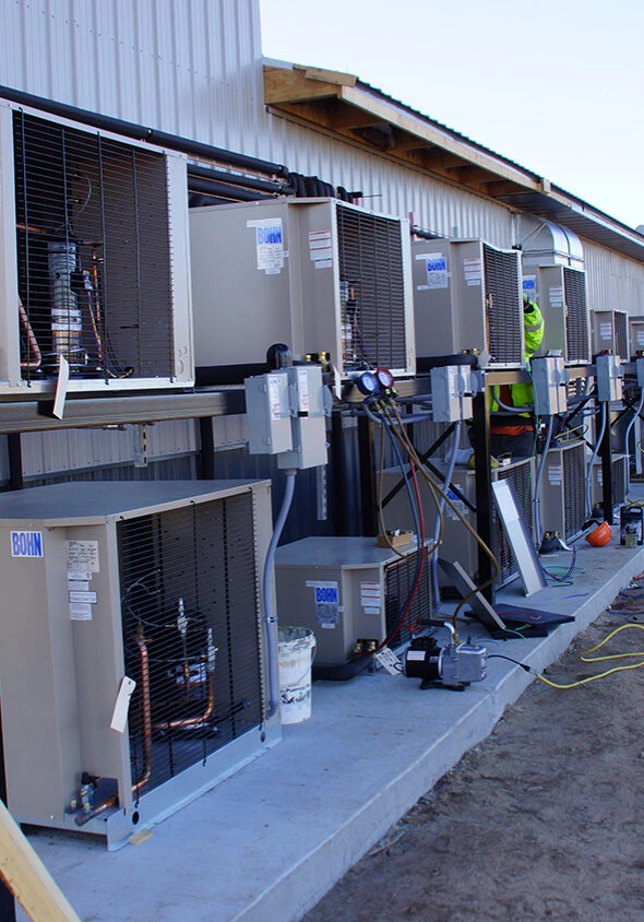 GenMech AC founder and team working on commercial HVAC equipment in Midland, TX