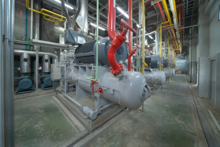 Commercial chiller units with refrigerant piping in a Midland, TX mechanical room during repair and diagnostics