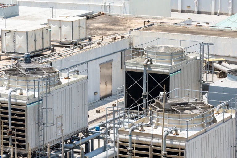 Rooftop cooling towers and condenser water piping on an industrial HVAC system in Midland, TX